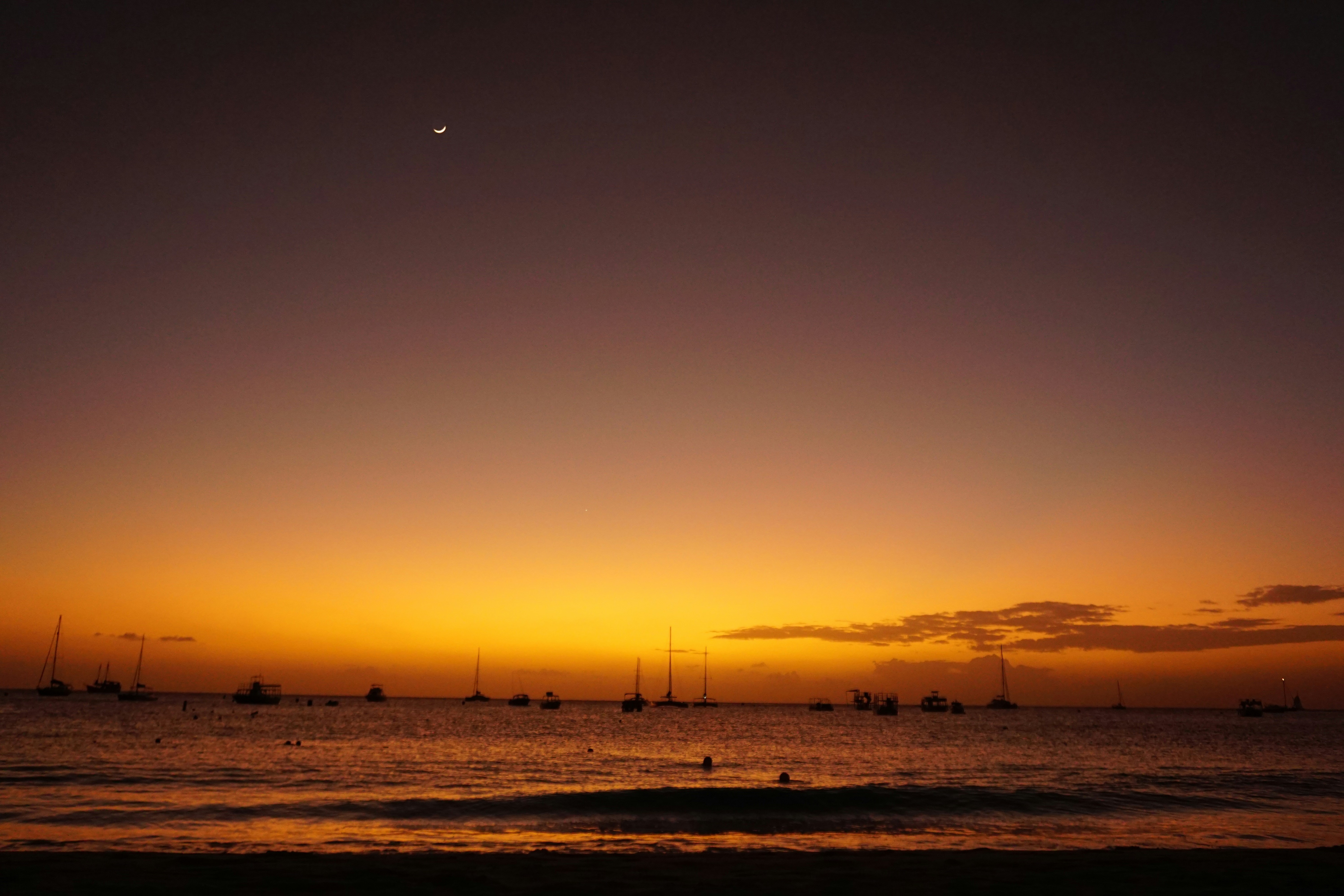 Sailboats silhouetted against sunset at Carlisle Bay, Barbados